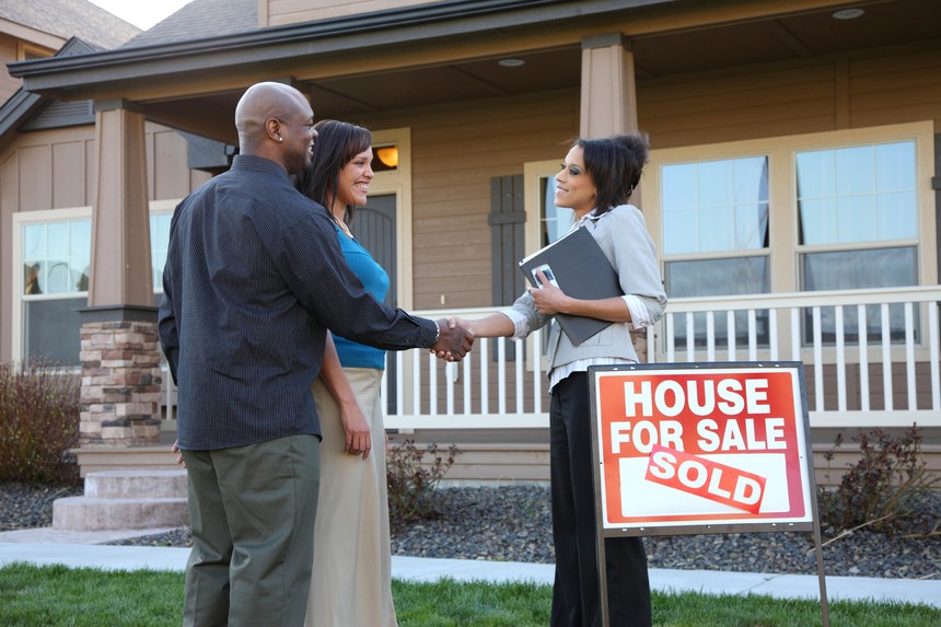 couple-shakes-hands-with-realtor-house-sold.jpg