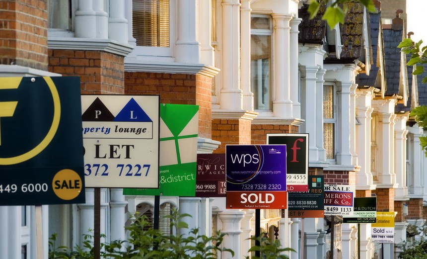 1498349627-row-of-houses-with-for-sale-signs-in-front-of-them.jpg