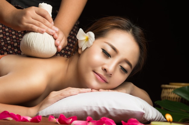asian-woman-getting-thai-herbal-compress-massage-spa_50889-6.jpg
