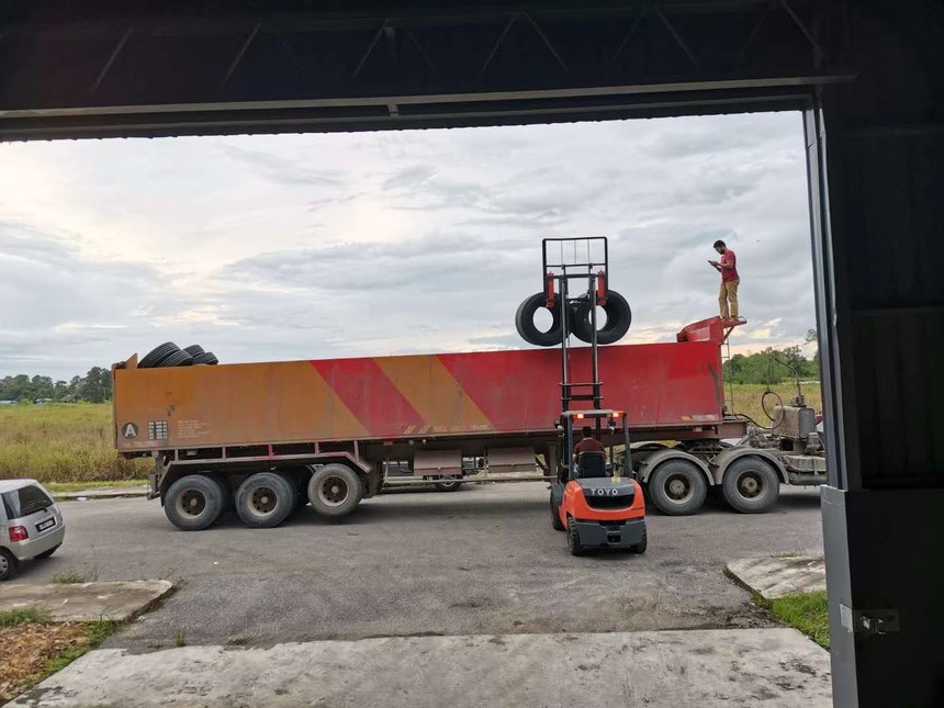 A large truck loads HuaanTire
