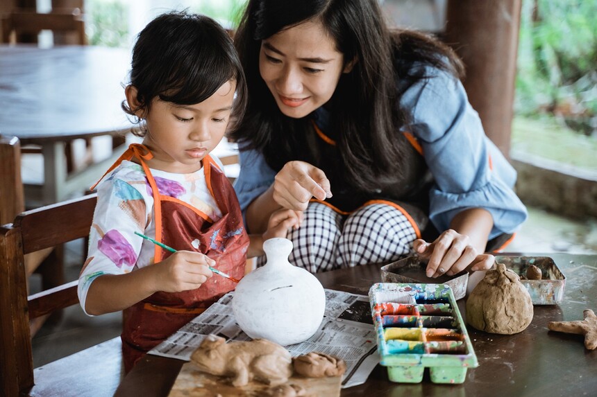 mother and daughter painting ceramic pot.jpg
