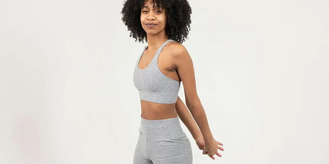 Young-woman-with-curly-hair-stretching-in-sportswear-on-a-white-background-by-Monstera-Production.webp.jpg
