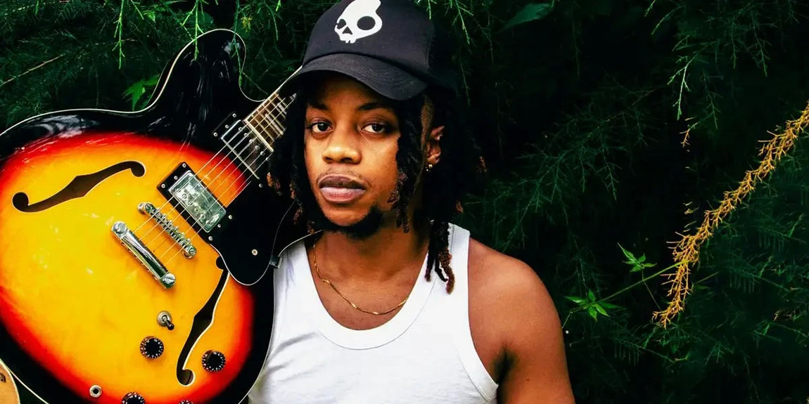 A-man-holding-a-guitar-in-front-of-a-tree-by-Dwayne-joe.webp.jpg