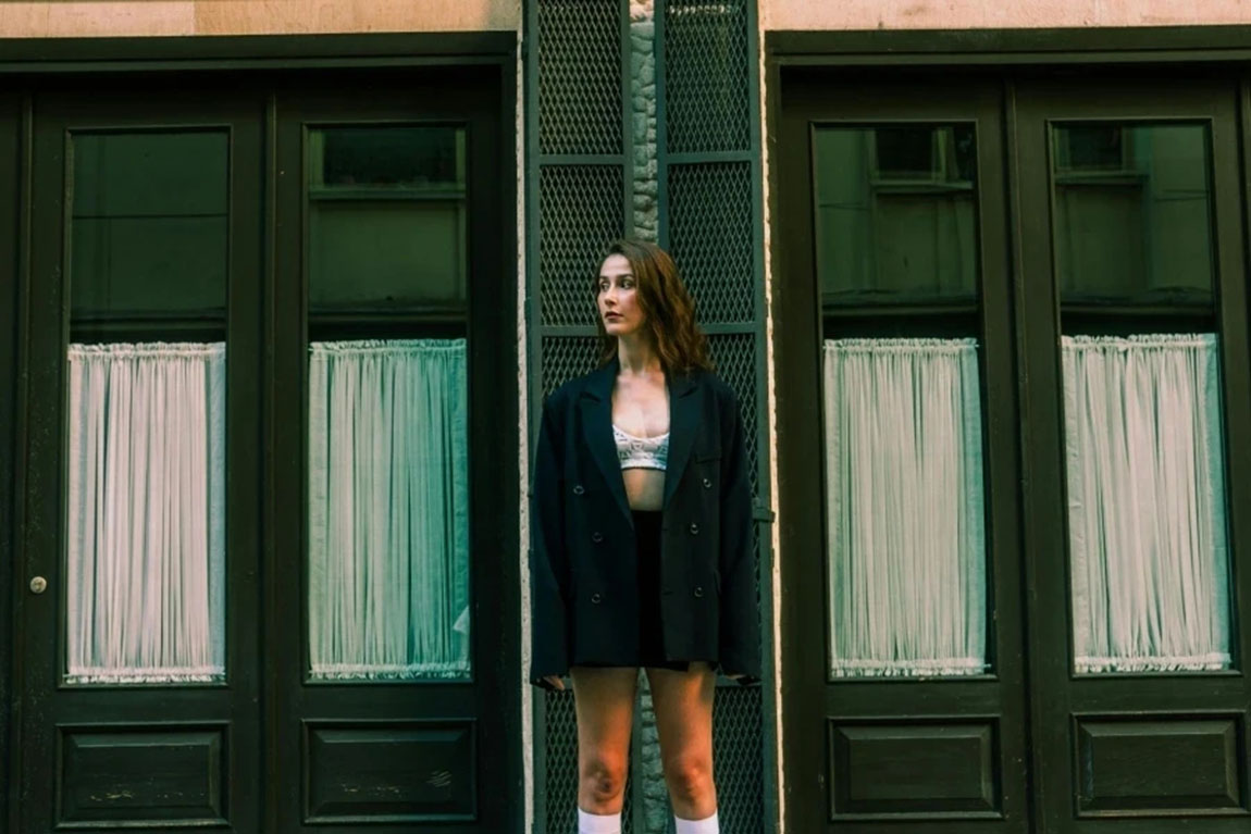 Woman-Standing-in-Black-Jacket-and-Bra.webp.jpg