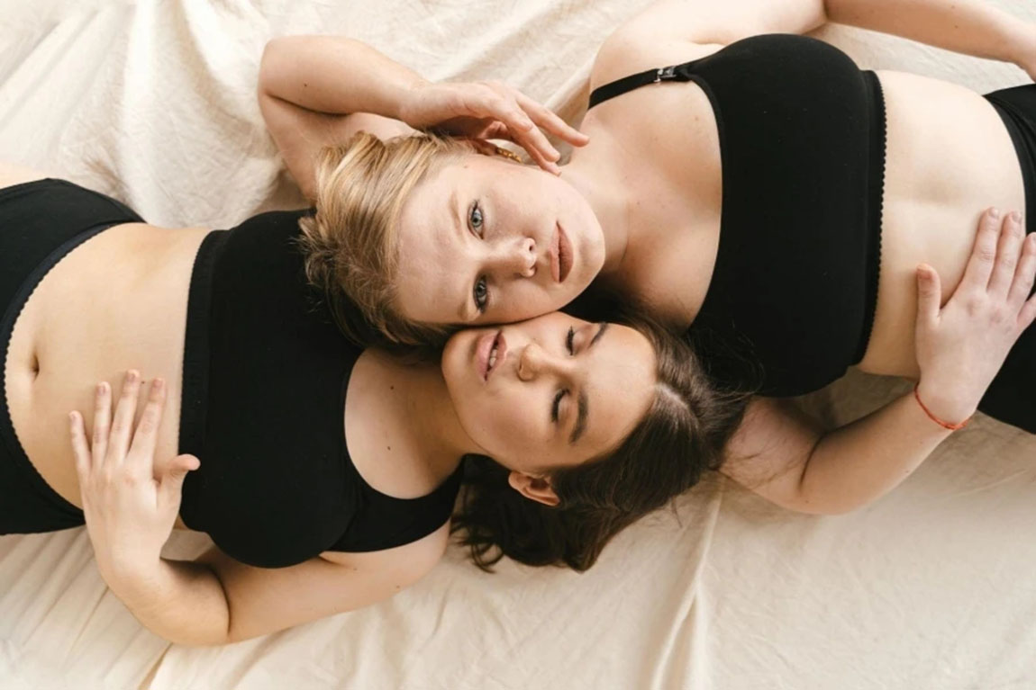 Women-in-black-bralette-lying-down-together.webp.jpg