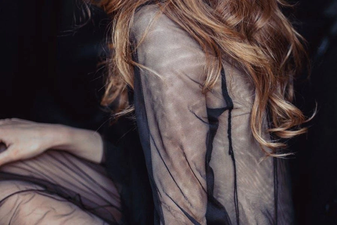 A-woman-wearing-a-sheer-dress-in-a-car.webp.jpg