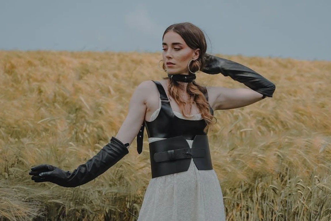 A-woman-wearing-a-black-cincher-in-a-field.webp.jpg