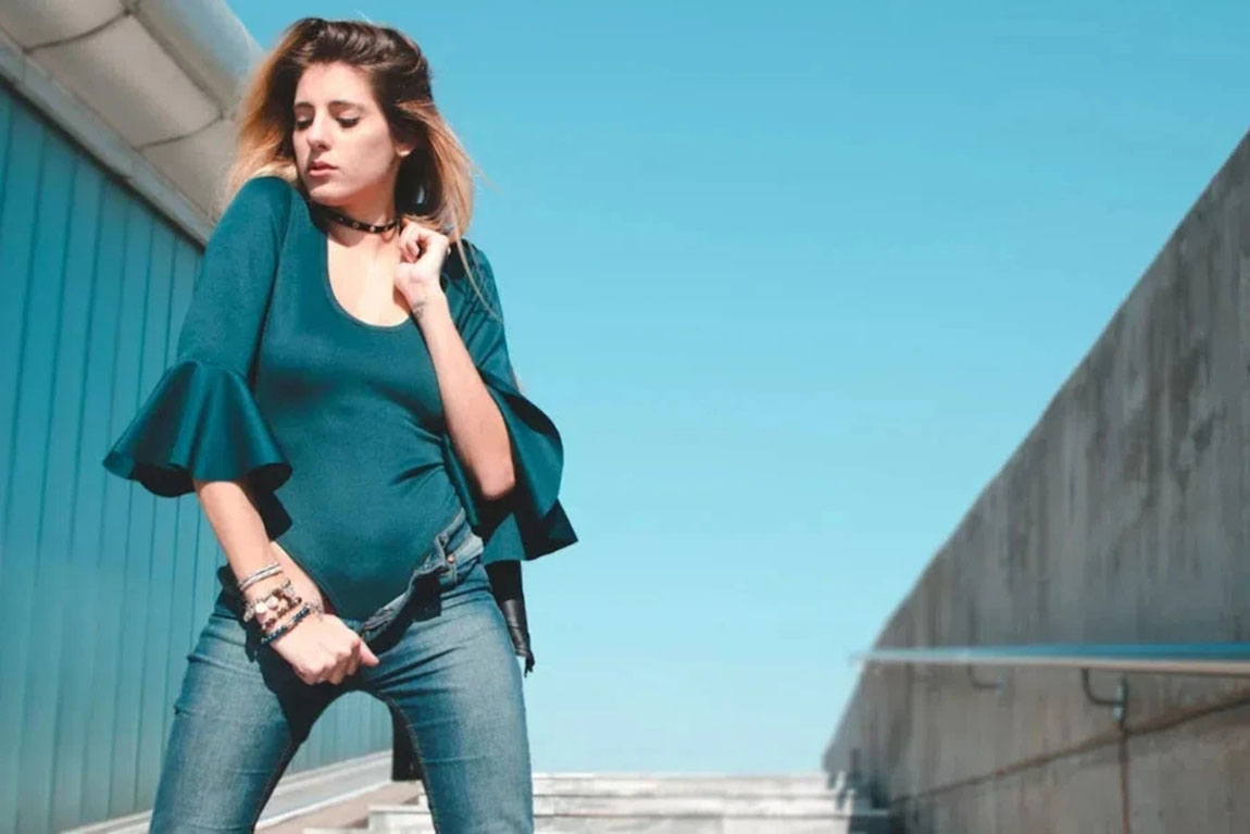 woman-in-green-bodysuit-and-jeans.webp.jpg