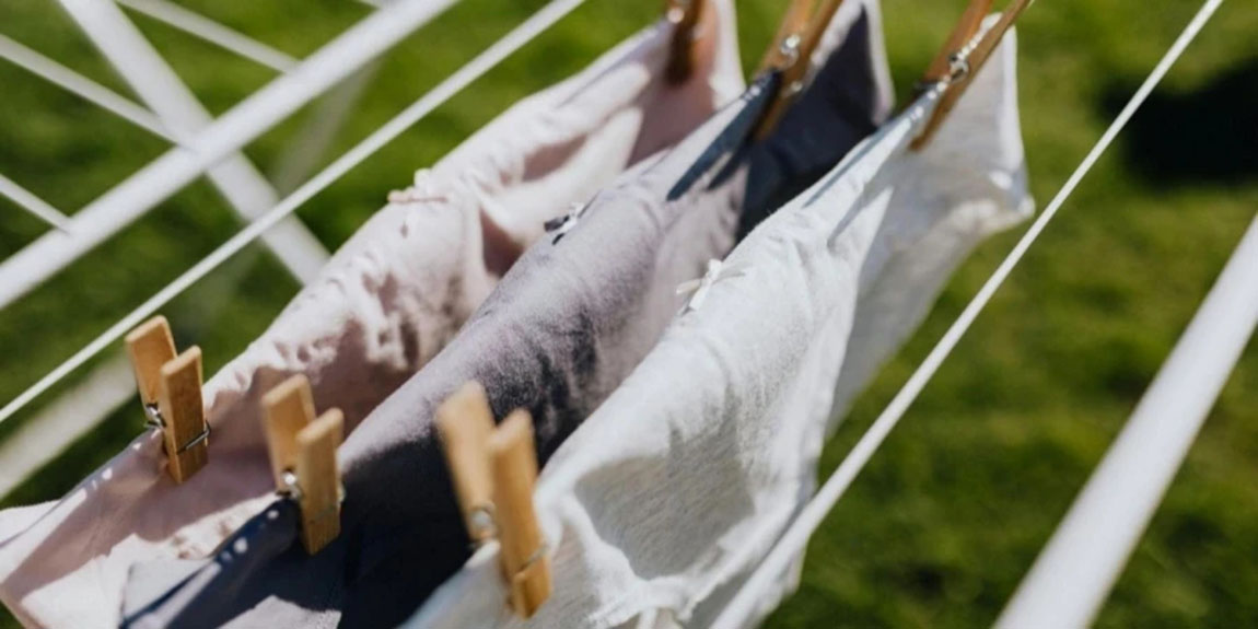Linen-with-Clothespins-Attached-to-Rail-in-Yard.webp.jpg