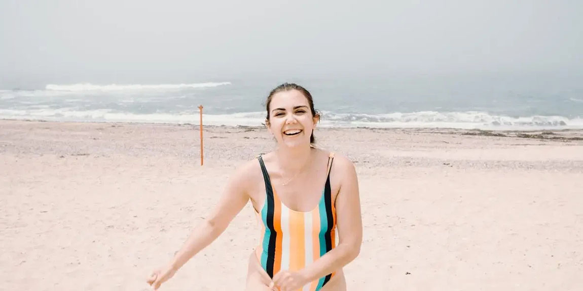 Woman-Walks-Towards-The-Camera-On-A-Beach.webp.jpg
