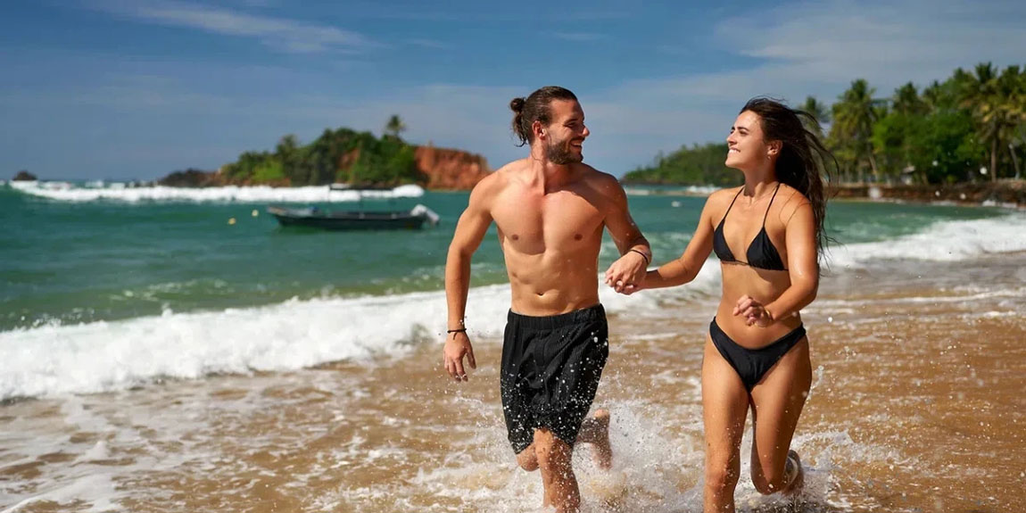 Joyful-couple-runs-on-tropical-beach-1.webp.jpg