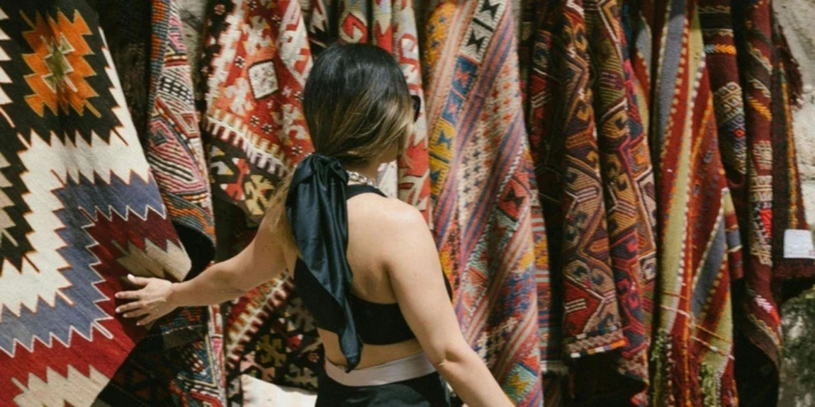 Woman-Shopping-for-Blanket-at-Market.webp.jpg