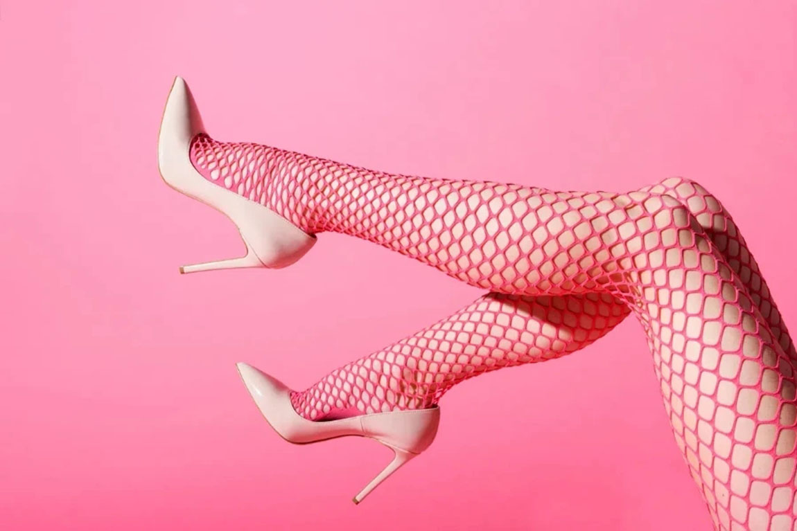 Slender-female-legs-raised-in-sexy-pink-fishnets.webp.jpg
