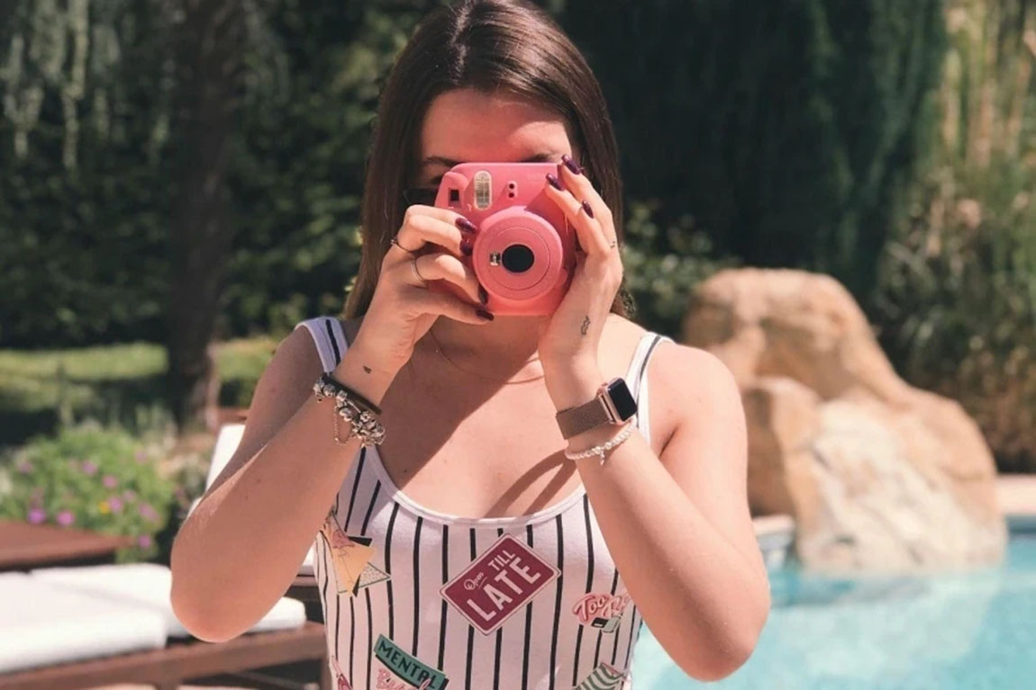 Woman-Holding-Pink-Instant-Camera.webp.jpg