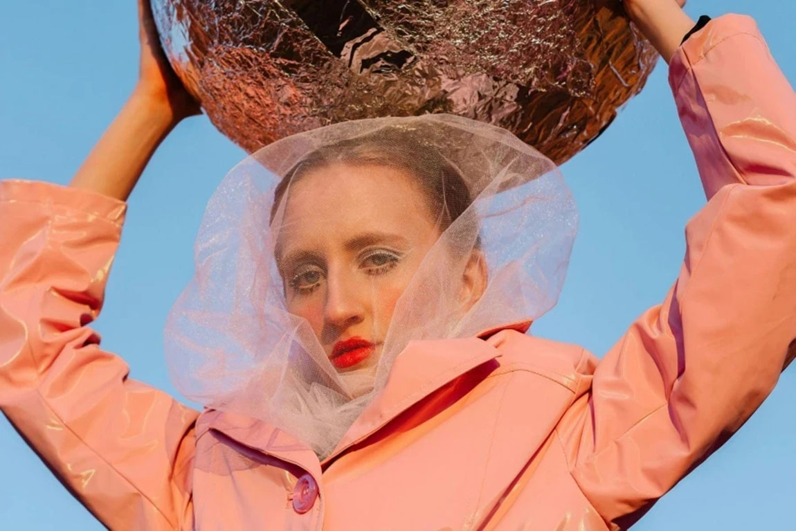 A-Woman-in-a-Pink-Top-Holding-a-Ball-Covered-with-Foil.webp.jpg