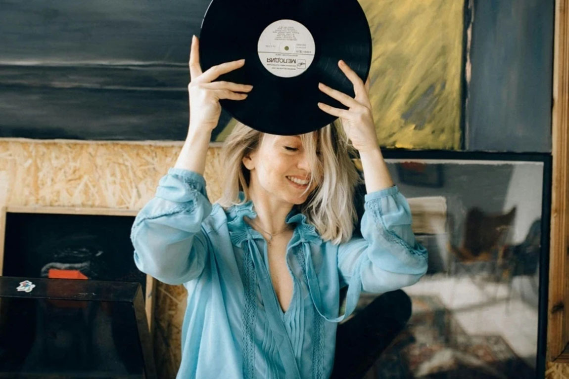 Woman-holding-record.webp.jpg
