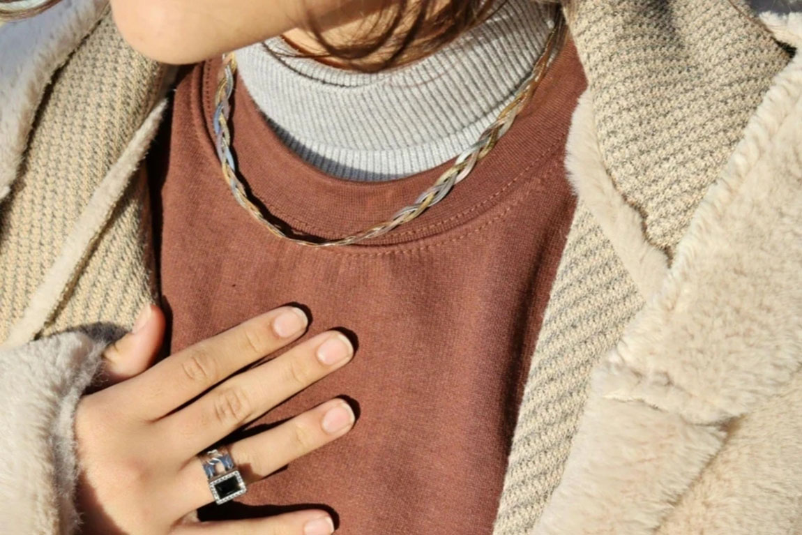 A-Close-Up-Shot-of-a-Person-Wearing-a-Necklace-and-a-Ring.webp.jpg