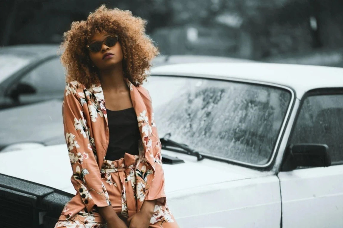 Woman-Wearing-Brown-Floral-Print-Coat-and-Pants-Sitting-on-Car.webp.jpg