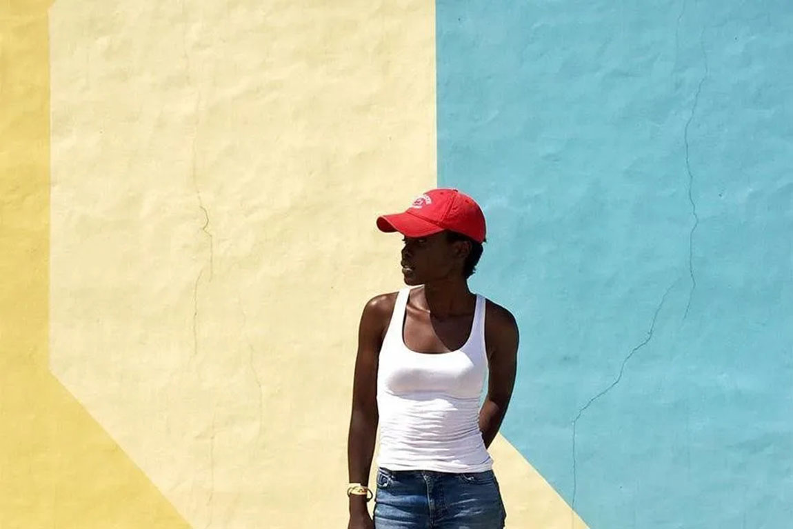 woman-wearing-a-white-tank-top-and-a-red-hat.webp.jpg