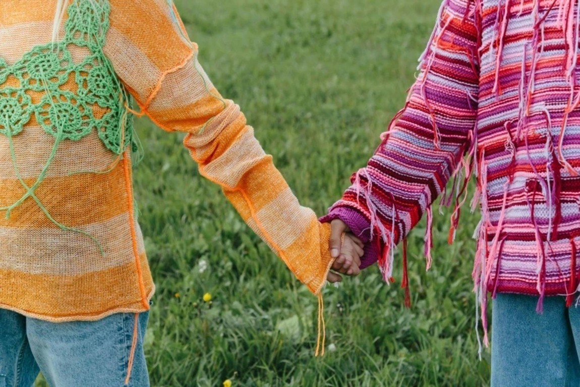Persons-in-Striped-Knitted-Sweaters-Holding-Hands.webp.jpg
