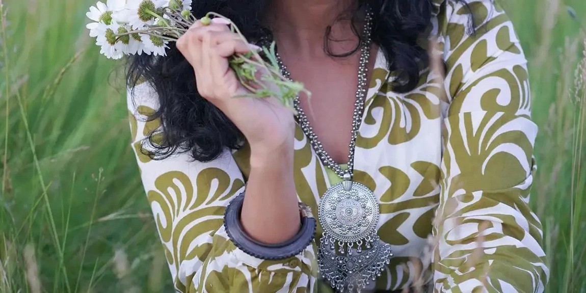 A-fashionable-woman-in-a-meadow-holding-wildflowers-showcasing-a-blend-of-elegance-and-nature-by-AAs-Photography.webp.jpg