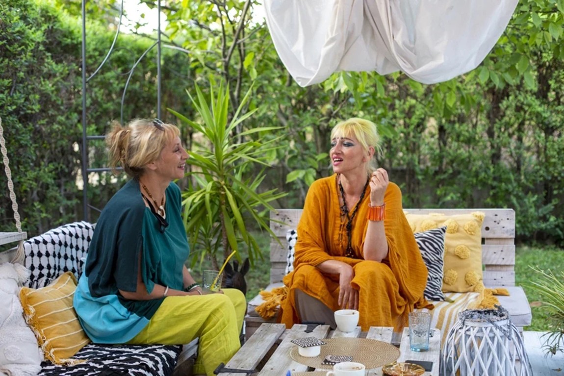 A-blonde-woman-wearing-an-orange-v-neck-kaftan.webp.jpg