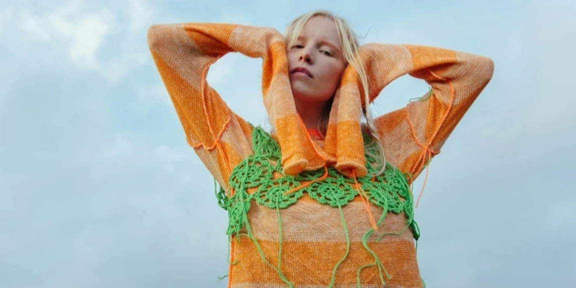 A-Woman-in-Orange-Knit-Sweater-and-Green-Crochet-Top.webp.jpg