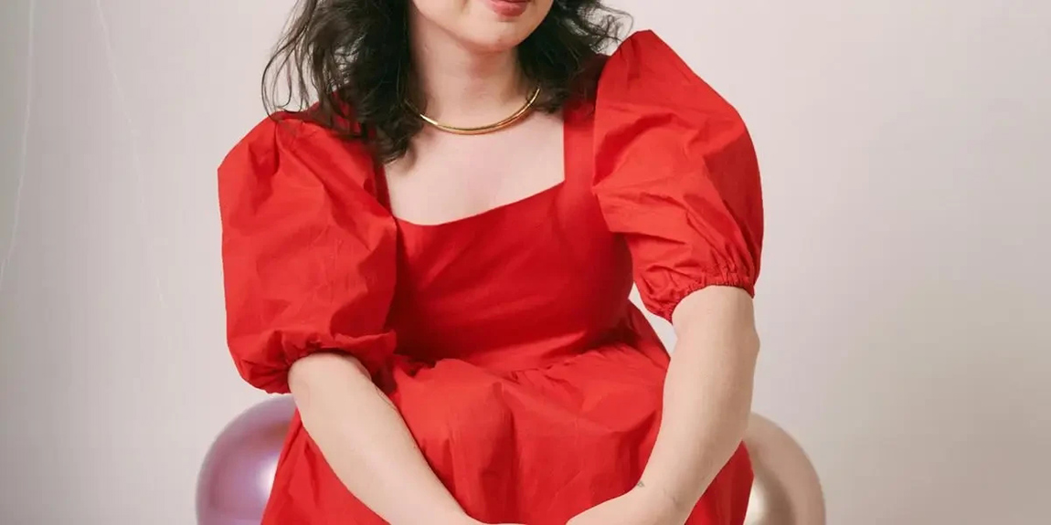 Stylish-young-woman-in-red-dress-poses-elegantly-indoors.-Trendy-fashion-portrait-by-Manuel-Gamboa.webp.jpg