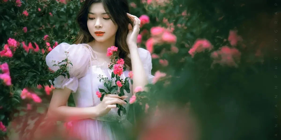 A-woman-gracefully-poses-amidst-vibrant-flowers-in-a-serene-summer-garden-by-hoang-anh.webp.jpg