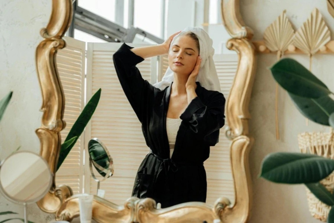 Woman-in-Black-Robe-Standing-in-Front-of-a-Mirror.webp.jpg