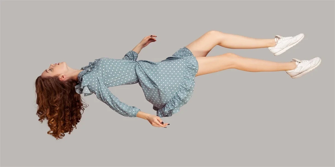 Relaxed-girl-in-vintage-ruffle-dress-levitating-keeping-eyes-closed.webp.jpg