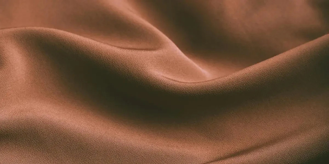From-above-of-elegant-brown-draped-silk-fabric-with-smooth-texture-as-abstract-background-by-Anete-Lusina.webp.jpg