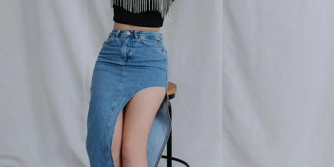 Stylish-woman-in-a-denim-skirt-and-crop-top-posing-indoors-showcasing-modern-fashion-by-ALINA-MATVEYCHEVA.webp.jpg