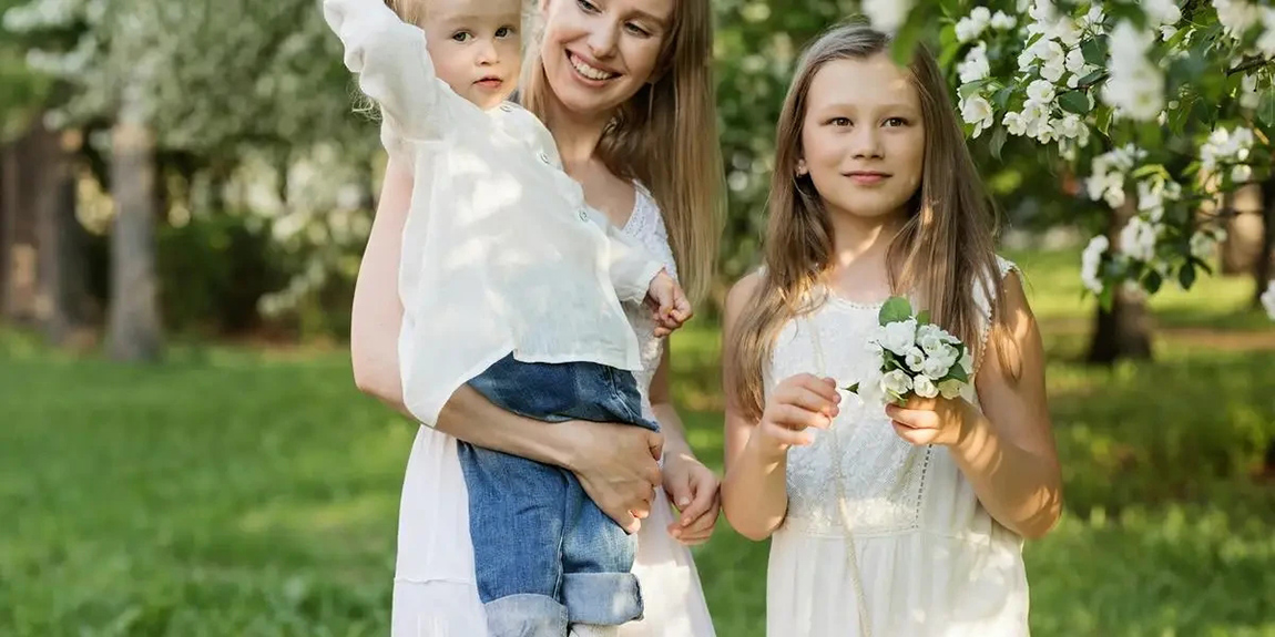 A-joyful-family-moment-with-mother-and-children-in-a-blooming-park-by-Anastasiya-Gepp.webp.jpg