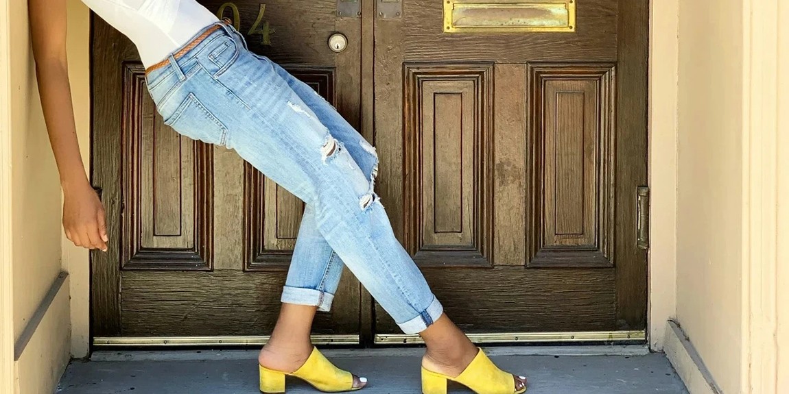 a-woman-leaning-against-the-door-of-a-house-by-Danielle-Bailey.webp.jpg