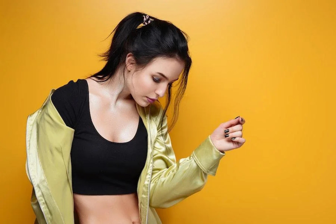 woman-posing-with-a-black-crop-top-and-open-jacket.webp.jpg