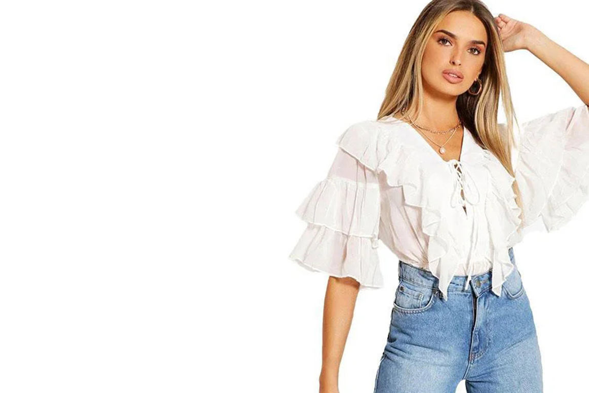 lady-wearing-white-ruffle-blouse-and-blue-denim-pants.webp.jpg