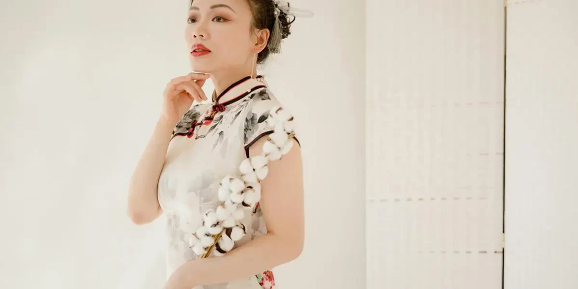 An-elegant-woman-in-a-floral-qipao-dress-poses-indoors-with-refined-sophistication-by-RDNE-Stock-project.webp.jpg