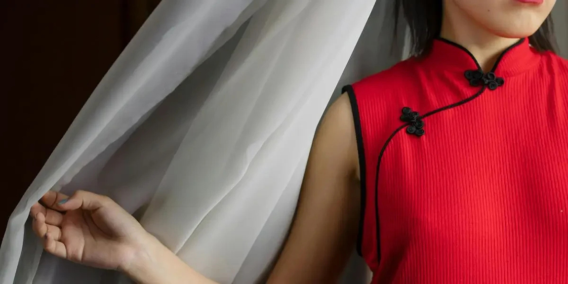 Close-up-of-an-elegant-woman-in-a-red-qipao-dress-and-red-lipstick-indoors-by-cottonbro-studio.webp.jpg