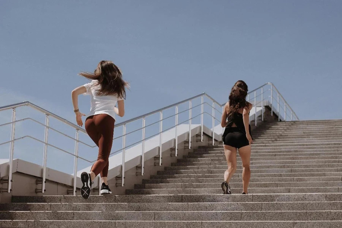 2-Women-Walking-on-Gray-Concrete-Bridge.webp.jpg