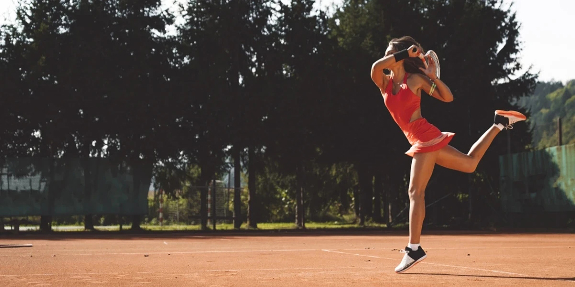 Female-tennis-player-on-clay-court-wearing-red-tennis-dress.webp.jpg