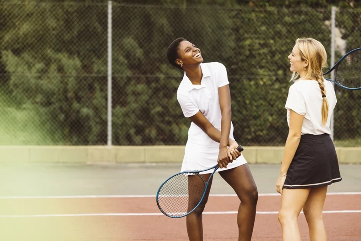 Two-women-talking-on-court-at-public-tennis-club.webp.jpg