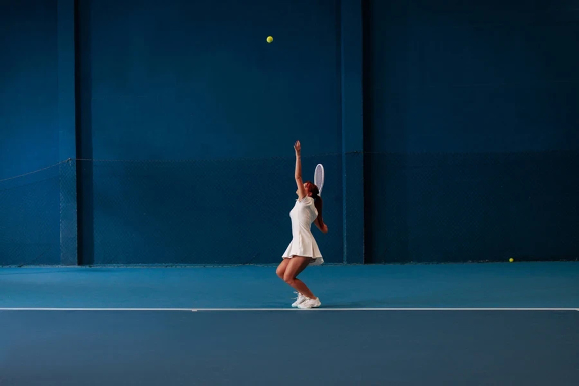Girl-serving-on-edge-of-court-with-matching-shoes.webp.jpg