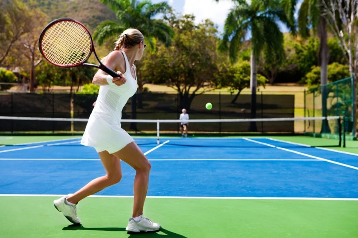 Woman-hitting-ball-on-court-in-the-summer.webp.jpg