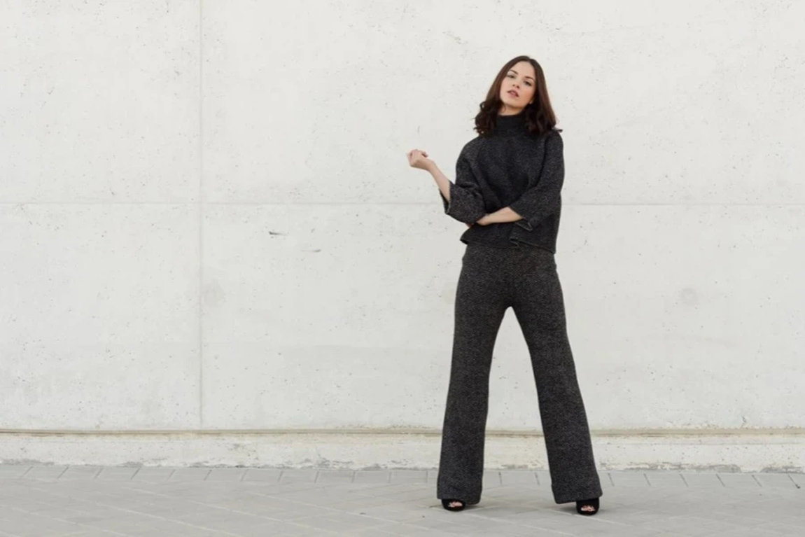 Portrait-Of-Young-Woman-Standing-Against-Wall.webp.jpg