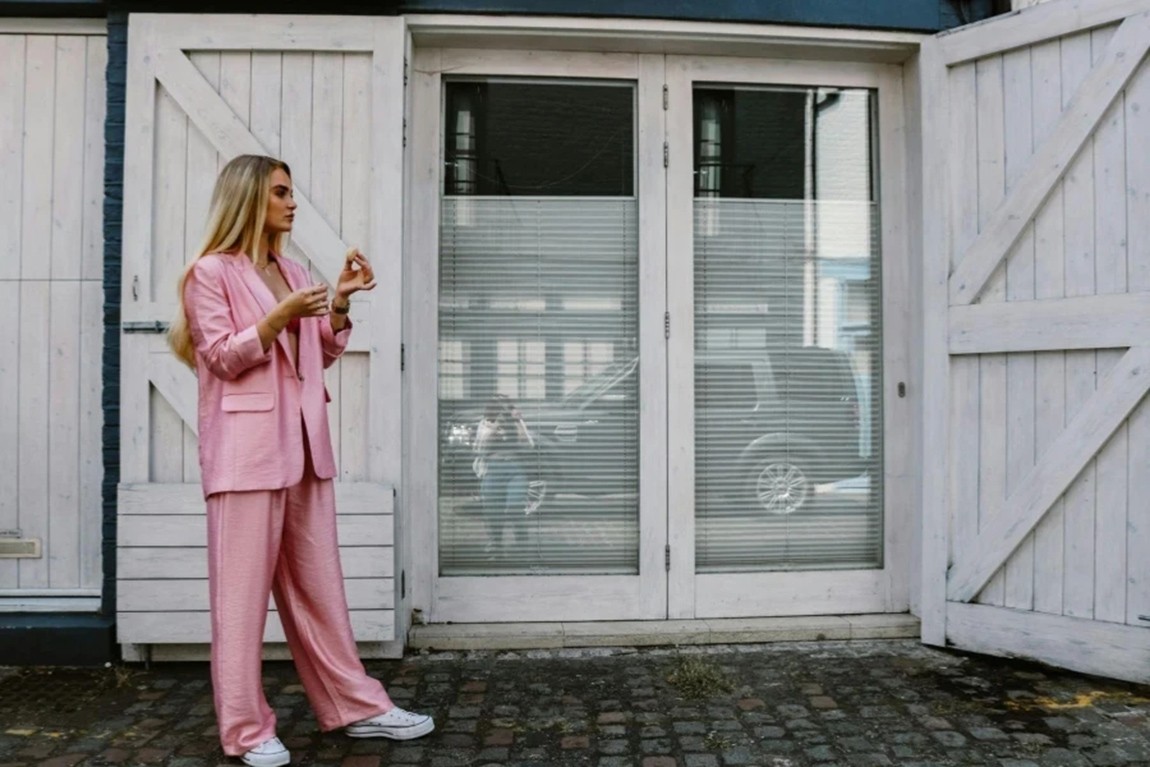 Woman-in-Pink-Clothes-Posing-by-Wooden-Door.webp.jpg
