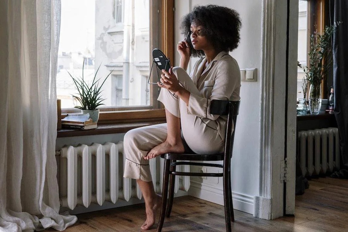 lady-in-a-cream-colored-pajamas-set-on-a-chair.webp.jpg