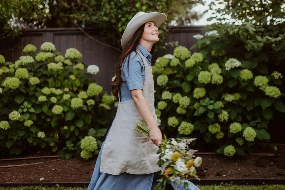 Woman-in-a-cowgirl-hat-carrying-flowers.webp.jpg