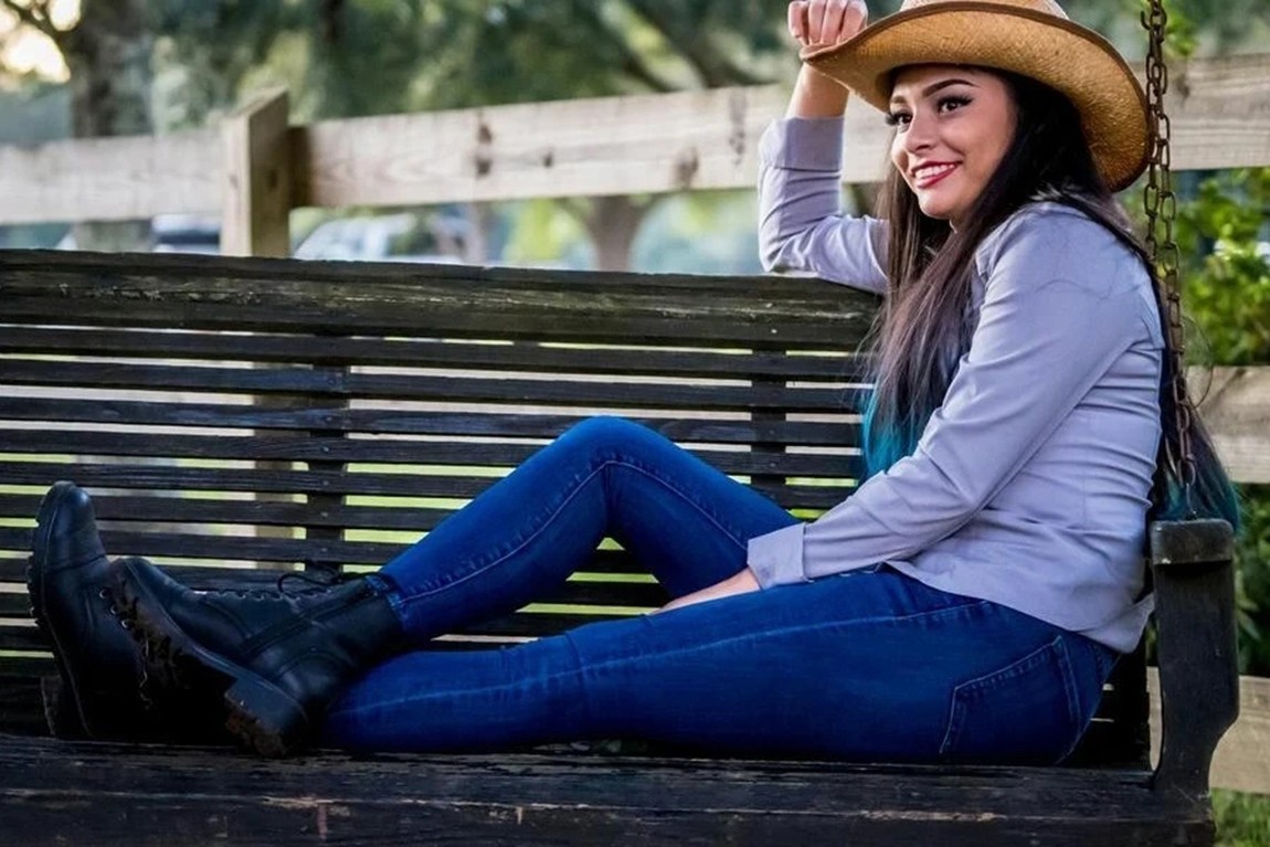 Smiling-woman-in-a-jeans-styled-cowgirl-outfit.webp.jpg