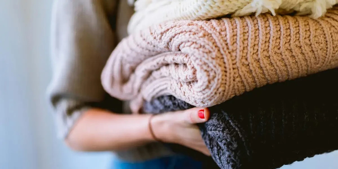 person-holding-knitted-textiles-by-Dan-Gold.webp.jpg